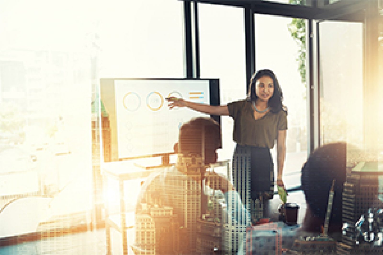 Woman giving presentation at group office meeting